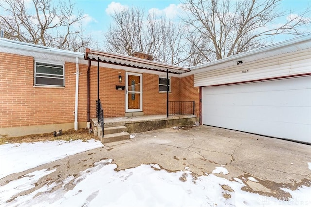 view of front of home featuring brick siding, driveway, and an attached garage