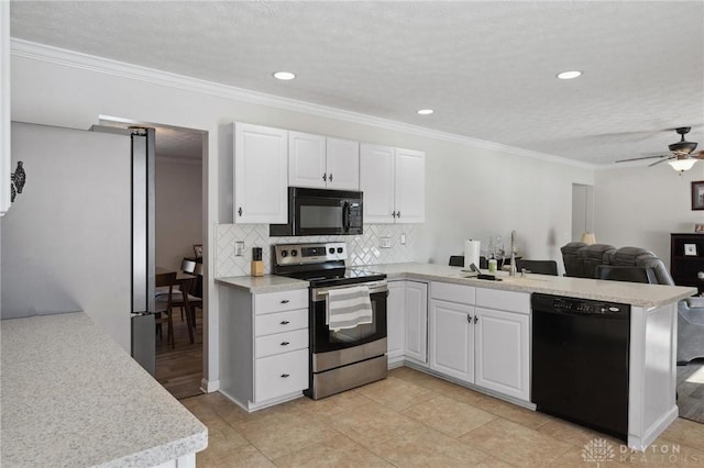 kitchen featuring black appliances, a peninsula, light countertops, and white cabinets