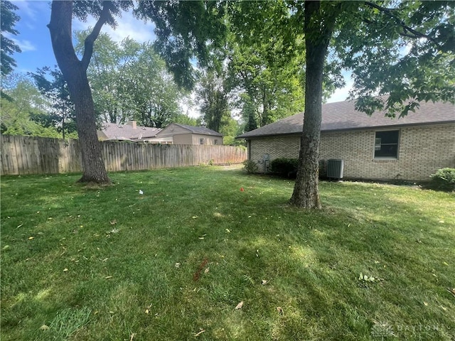 view of yard with cooling unit and fence