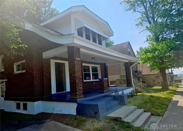 view of front of property featuring a porch and brick siding