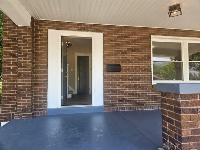 entrance to property with brick siding