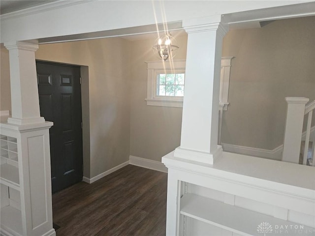 foyer entrance with baseboards, dark wood-type flooring, and ornate columns