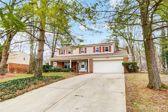 traditional home with a garage, brick siding, driveway, and a chimney