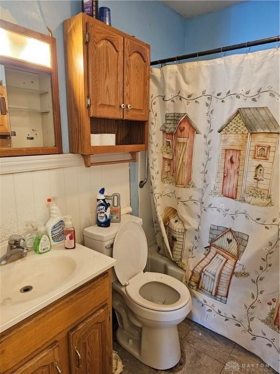 full bath featuring toilet, tile patterned flooring, and vanity