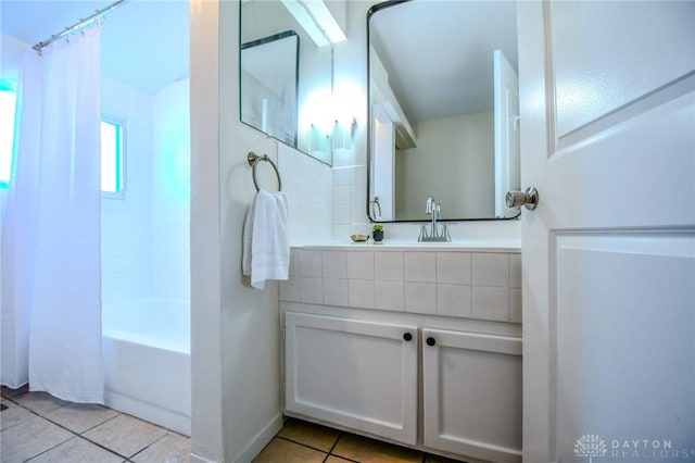 full bathroom featuring shower / bath combination with curtain, vanity, and tile patterned floors