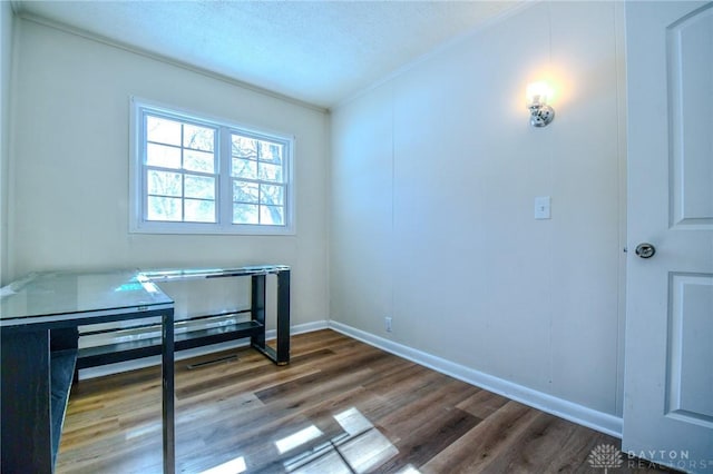 interior space featuring baseboards and wood finished floors