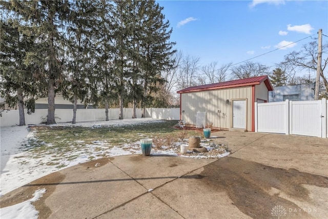 exterior space with an outbuilding, a fenced backyard, and a patio