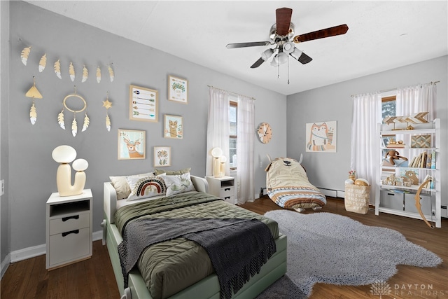 bedroom with dark wood-style floors, a baseboard radiator, baseboards, and a ceiling fan