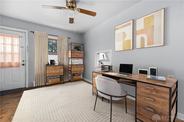 home office with wood finished floors, a ceiling fan, and baseboards