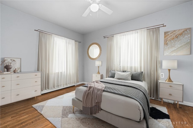 bedroom with dark wood-style floors and ceiling fan