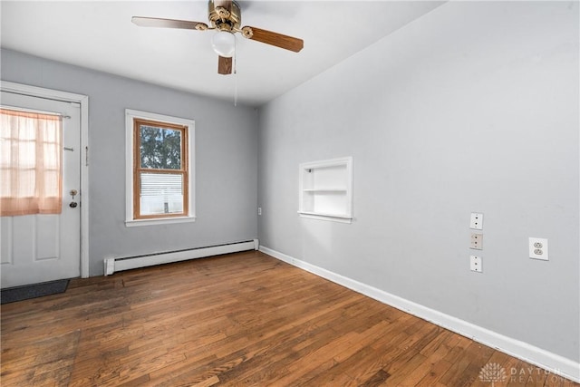 spare room featuring dark wood-style floors, a baseboard radiator, baseboards, and ceiling fan