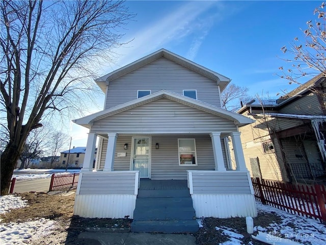 view of front facade featuring covered porch and fence