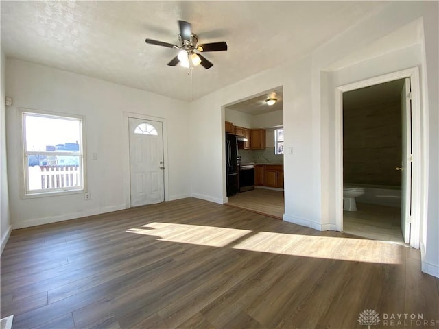 entryway with ceiling fan, wood finished floors, and baseboards