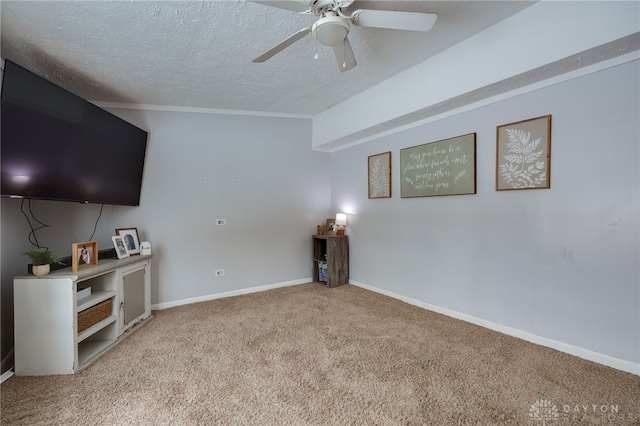 unfurnished living room with baseboards, carpet, a ceiling fan, and a textured ceiling