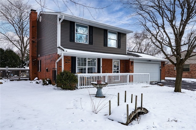 traditional-style house featuring brick siding, an attached garage, covered porch, and a chimney