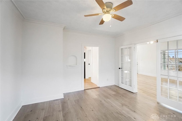 unfurnished room featuring ornamental molding, light wood finished floors, and baseboards