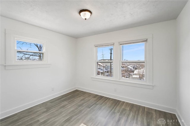 spare room featuring baseboards and a healthy amount of sunlight