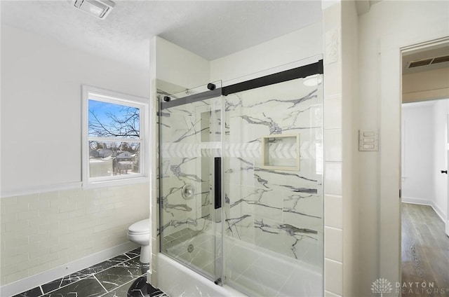 full bathroom with toilet, marble finish floor, visible vents, and a textured ceiling