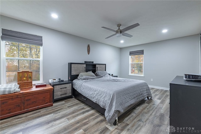 bedroom featuring ceiling fan, baseboards, wood finished floors, and recessed lighting