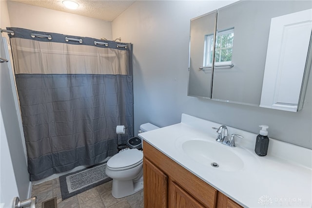 bathroom featuring visible vents, a shower with shower curtain, toilet, a textured ceiling, and vanity