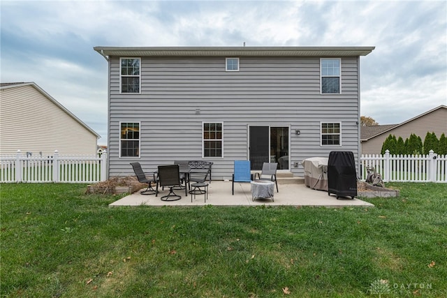 back of house featuring fence, a patio, and a yard