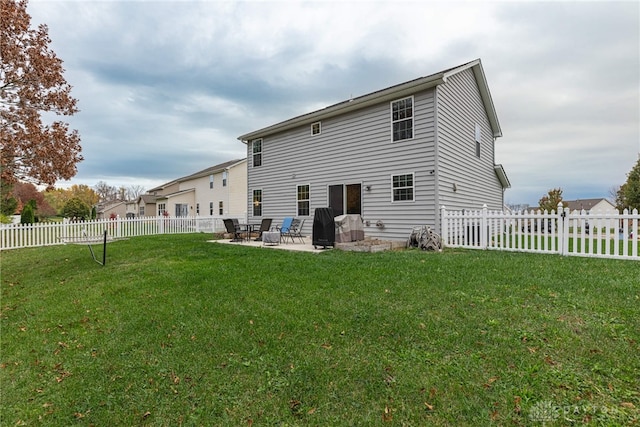 rear view of property with a fenced backyard, a patio, and a lawn