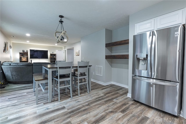 dining room with recessed lighting, visible vents, baseboards, and wood finished floors