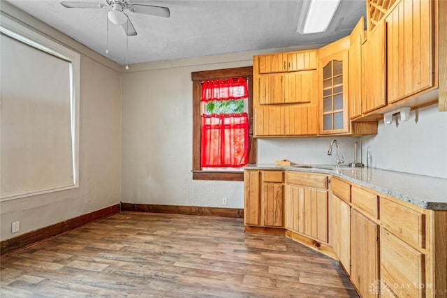 310 E Maple Ave, Miamisburg, OH 45342 - kitchen featuring a sink, wood finished floors, ceiling fan, and baseboards