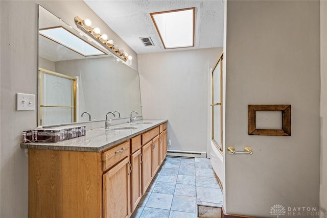 310 E Maple Ave, Miamisburg, OH 45342 - bathroom with a baseboard heating unit, double vanity, and enclosed tub / shower combo