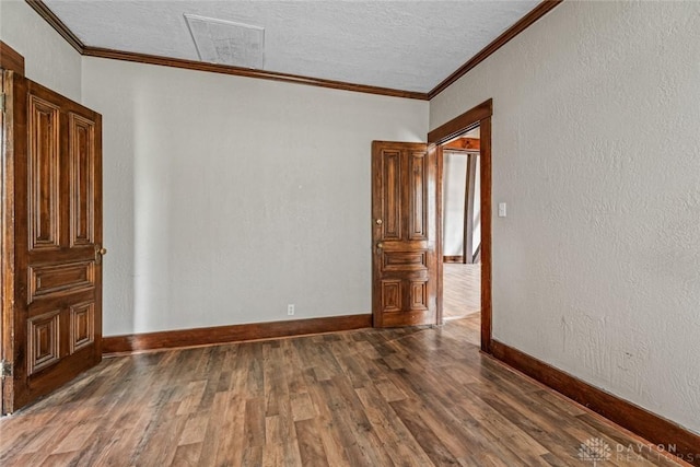 310 E Maple Ave, Miamisburg, OH 45342 - spare room featuring crown molding, wood finished floors, baseboards, and a textured ceiling