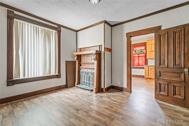 310 E Maple Ave, Miamisburg, OH 45342 - unfurnished living room featuring crown molding, a fireplace, wood finished floors, a textured ceiling, and baseboards