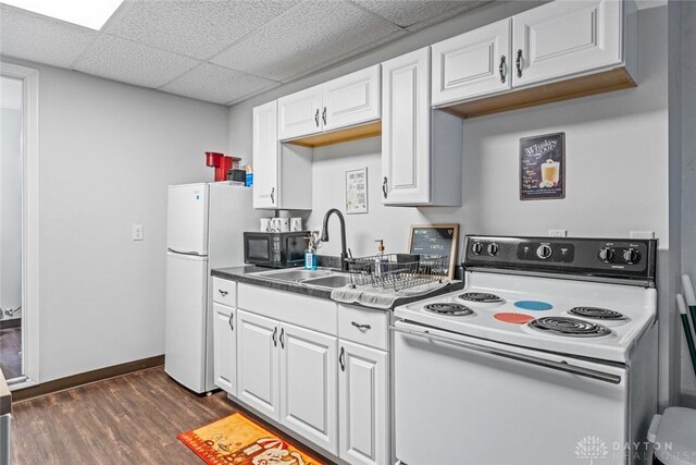 310 E Maple Ave, Miamisburg, OH 45342 - kitchen with white appliances, a sink, white cabinetry, dark wood finished floors, and a drop ceiling