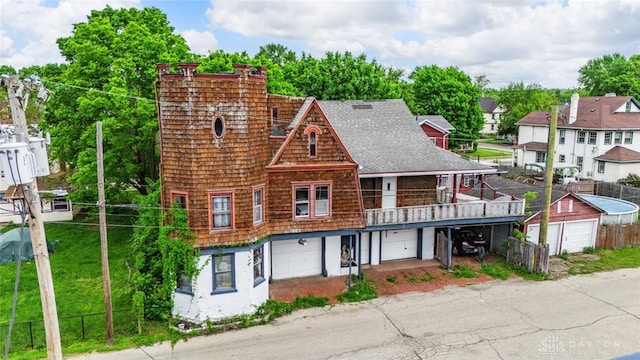 310 E Maple Ave, Miamisburg, OH 45342 - view of front of home with a garage, fence, a shingled roof, a balcony, and driveway