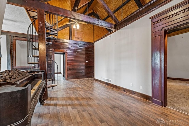 310 E Maple Ave, Miamisburg, OH 45342 - unfurnished living room featuring high vaulted ceiling, wood finished floors, baseboards, stairway, and beamed ceiling