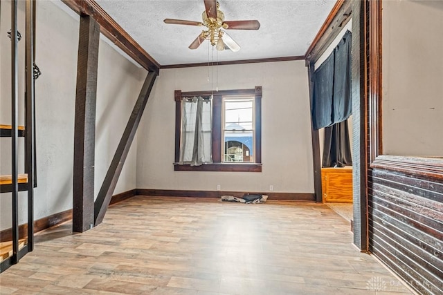 310 E Maple Ave, Miamisburg, OH 45342 - unfurnished bedroom featuring wood finished floors, ornamental molding, baseboards, a textured ceiling, and ceiling fan