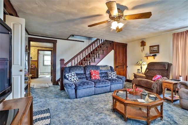 living area with ceiling fan, stairway, crown molding, carpet flooring, and a baseboard heating unit