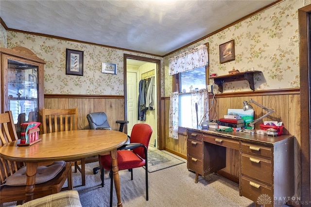 office area featuring a wainscoted wall, a textured ceiling, light carpet, and wallpapered walls