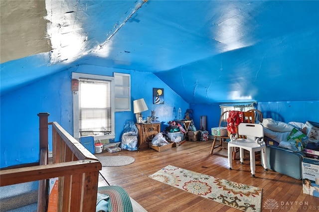 interior space featuring lofted ceiling and wood finished floors