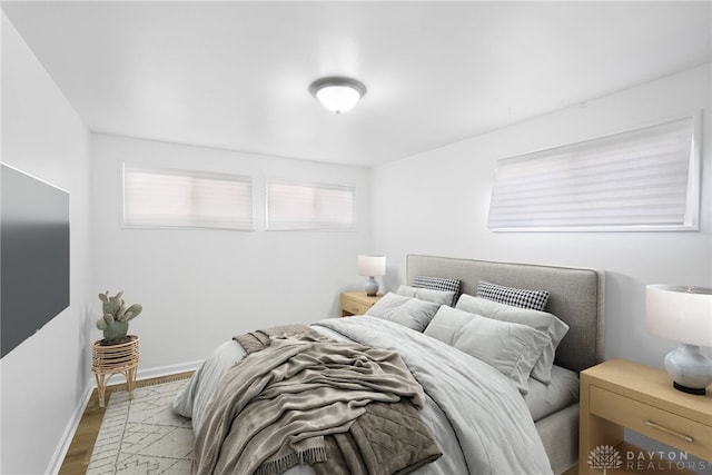 bedroom with light wood-style flooring and baseboards