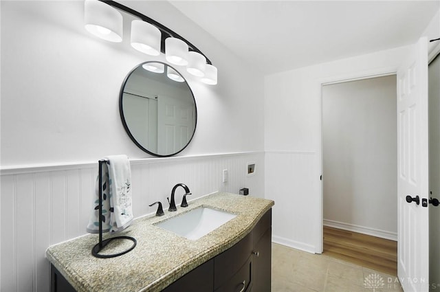 bathroom featuring a wainscoted wall, vanity, and tile patterned floors