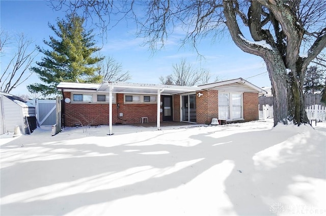 single story home with fence and brick siding