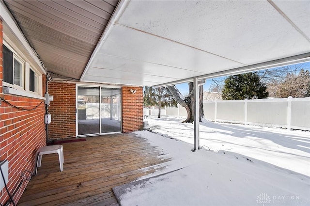 snow covered deck with fence