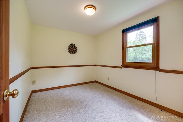 empty room with baseboards and carpet flooring