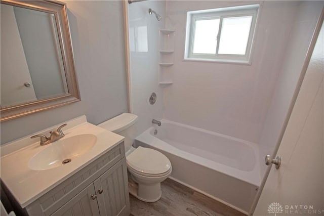 full bathroom featuring toilet, bathtub / shower combination, wood finished floors, and vanity