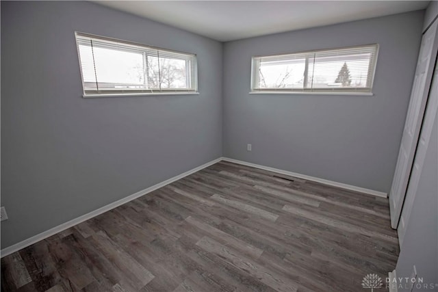 unfurnished room featuring wood finished floors and baseboards