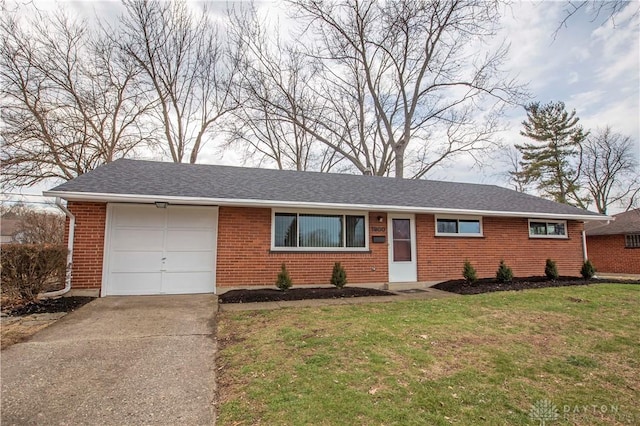 ranch-style home featuring brick siding, roof with shingles, a front yard, a garage, and driveway