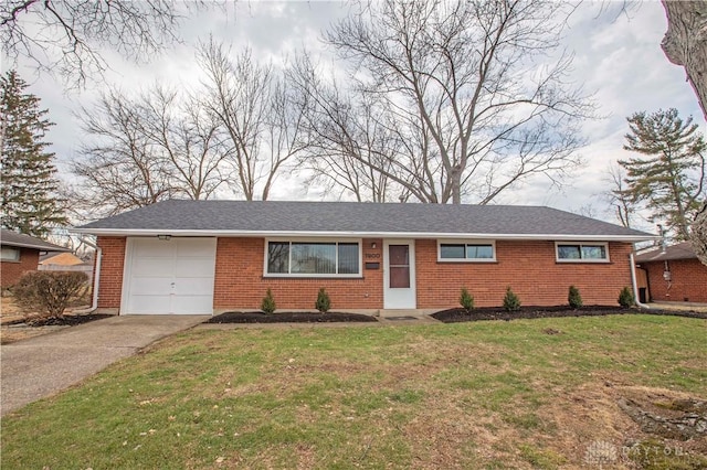 ranch-style home featuring brick siding, roof with shingles, an attached garage, a front yard, and driveway