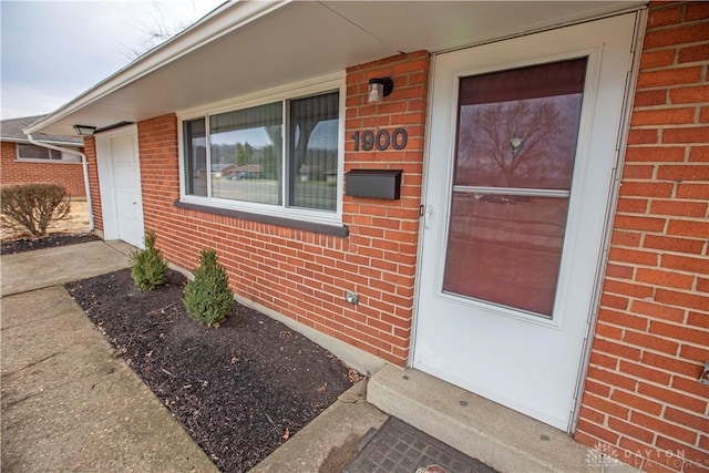 property entrance featuring brick siding