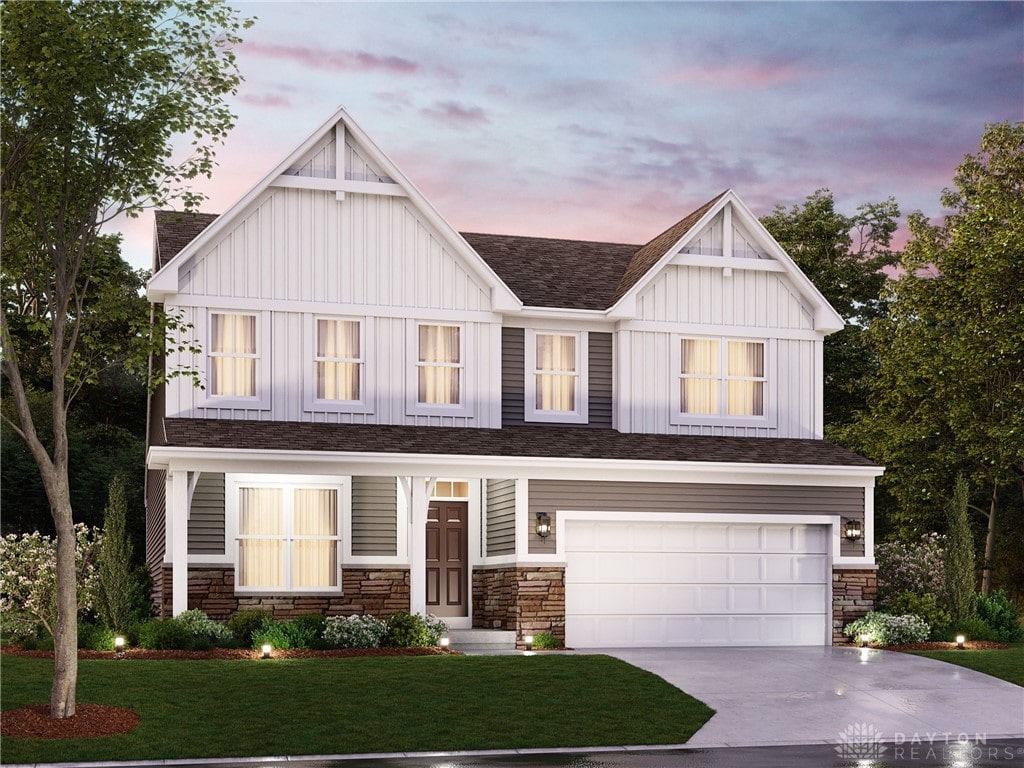 view of front of property featuring concrete driveway, board and batten siding, a front yard, a garage, and stone siding