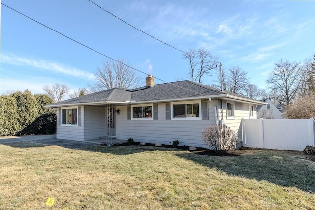 single story home with a front yard, roof with shingles, fence, and a chimney